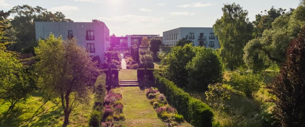 a view of a garden with a pink building at Lifehouse Spa And Hotel in Frinton-on-Sea