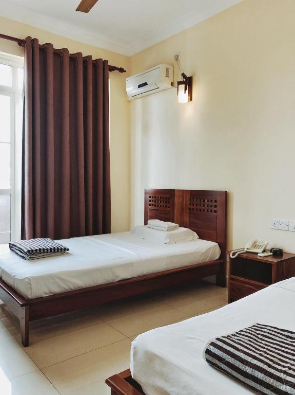 Postel nebo postele na pokoji v ubytování Lafala Hotel & Service Apartment