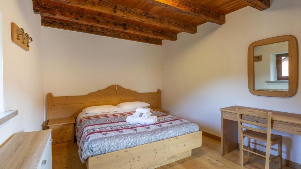 En eller flere senger på et rom på Albergo Diffuso Ravascletto