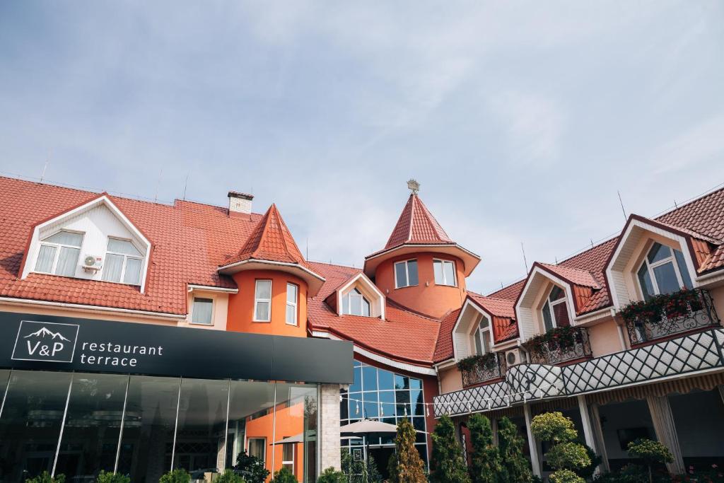 a building with a sign in front of it at V&P HOTEL & Restaurant in Khust