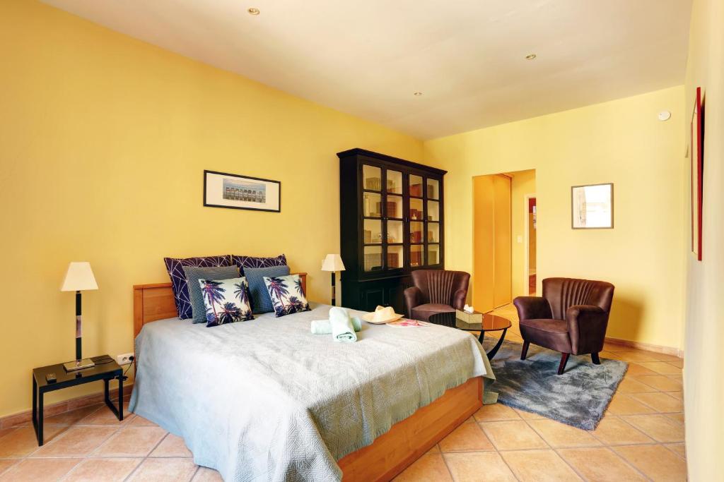 a bedroom with a bed and two chairs at FONTAINE - CHARMING PROVENCAL, Clim, 6 GUEST, OLD TOWN NICE in Nice