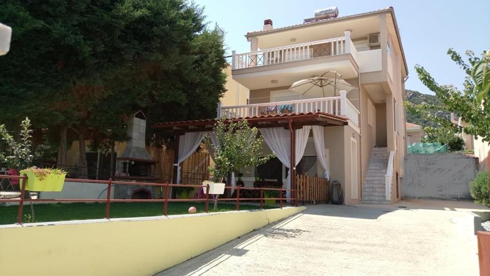 a large house with a balcony on the side of it at Fotis Resort in Iraklitsa