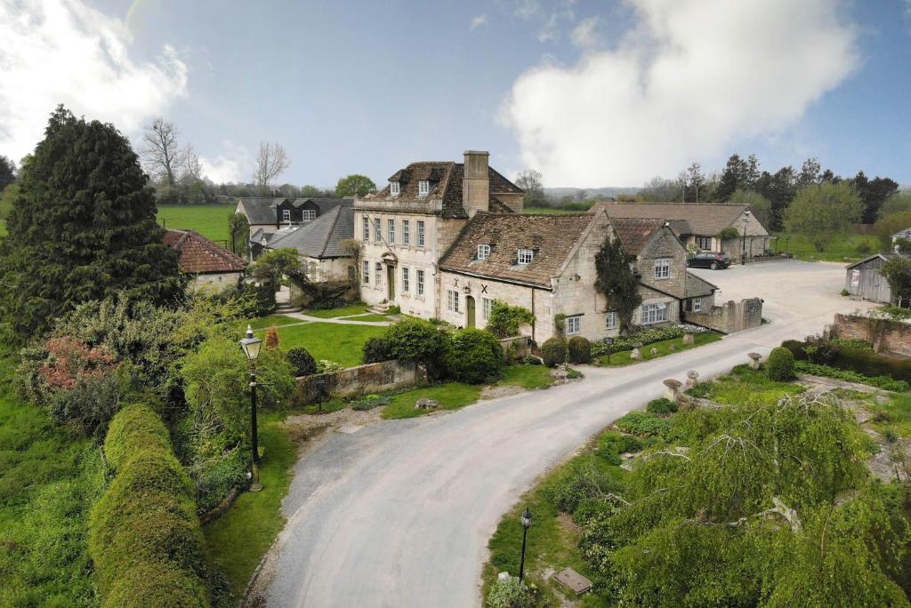 an old house on a road in a village at The Moonraker Hotel in Bradford on Avon