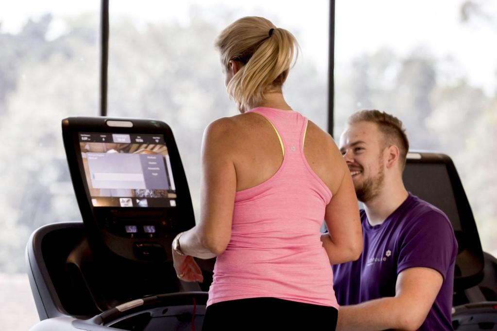 a man and a woman riding in a gym at Lifehouse Spa And Hotel in Frinton-on-Sea