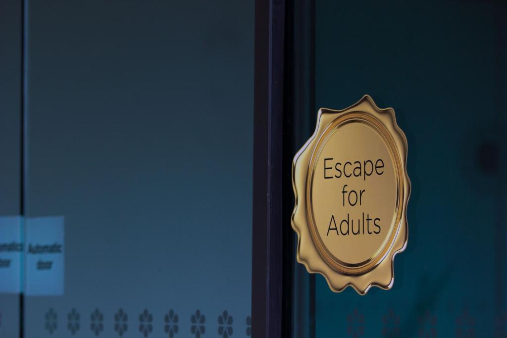 a sign on a door that reads escape for adults at Lifehouse Spa And Hotel in Frinton-on-Sea