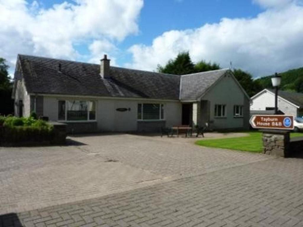 a house with a sign in front of it at Tayburn House in Dunkeld