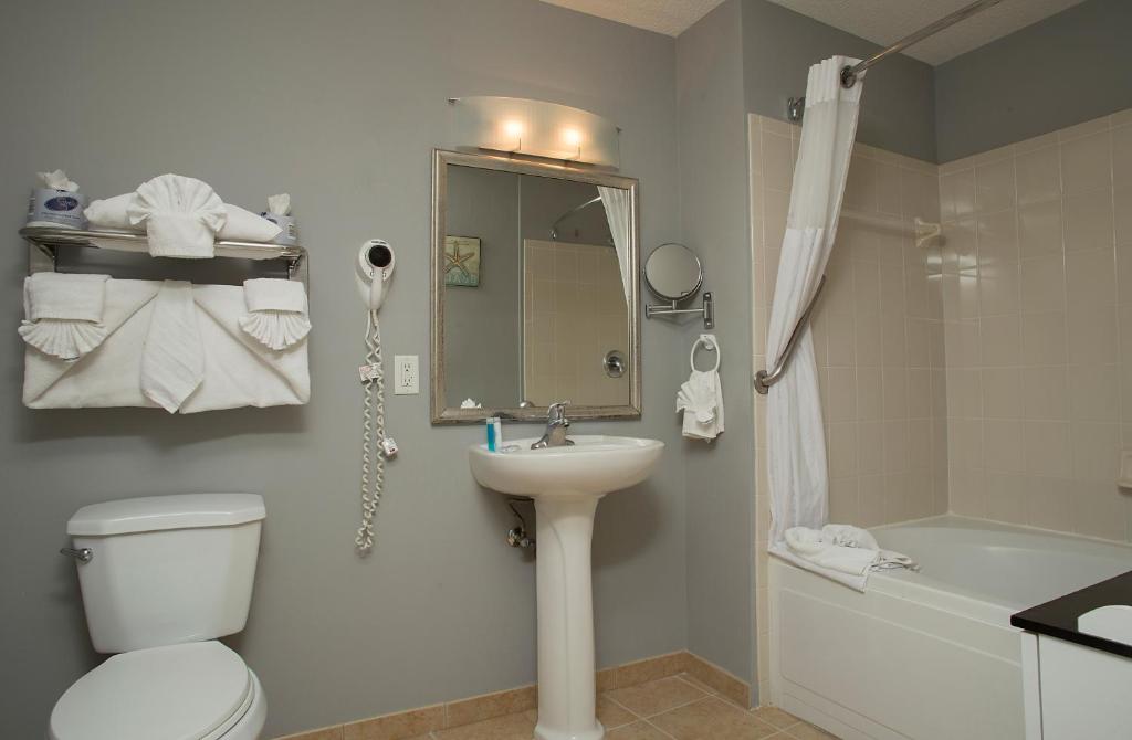a bathroom with a toilet and a sink and a shower at Avista Resort in Myrtle Beach