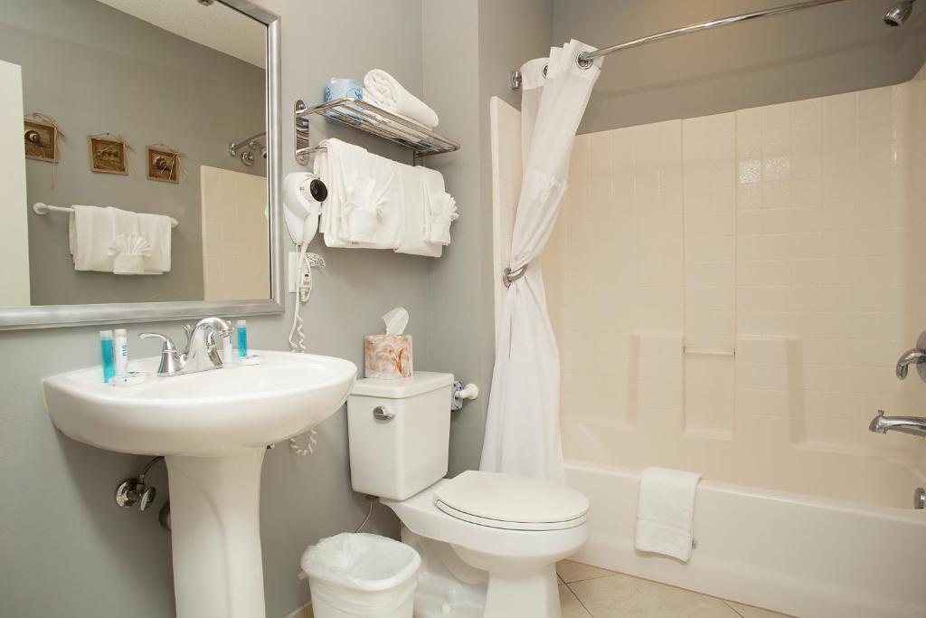 a bathroom with a toilet and a sink and a shower at Avista Resort in Myrtle Beach