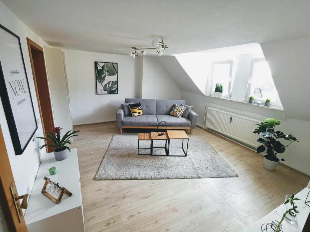 a living room with a couch and a table at Moderne 3BR Netflix,Kaffee,Wifi,Parken in Brand-Erbisdorf