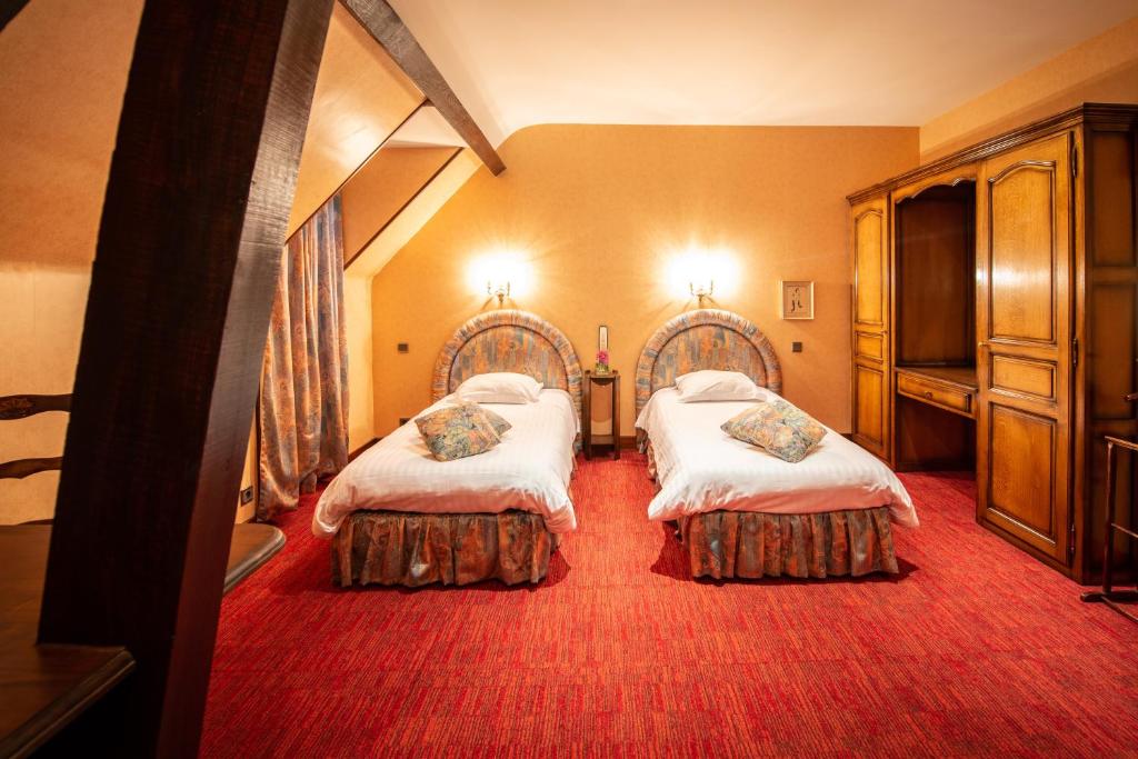 Postel nebo postele na pokoji v ubytování Hôtel Sainte Foy
