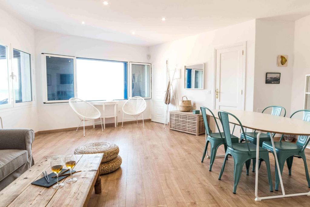 a living room with a table and chairs at Casa Delfín on Corralejo center beach: Wifi, Netflix, aircon... in Corralejo