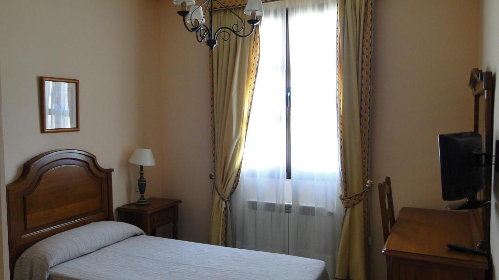 Postel nebo postele na pokoji v ubytování Hostal Las Paneras
