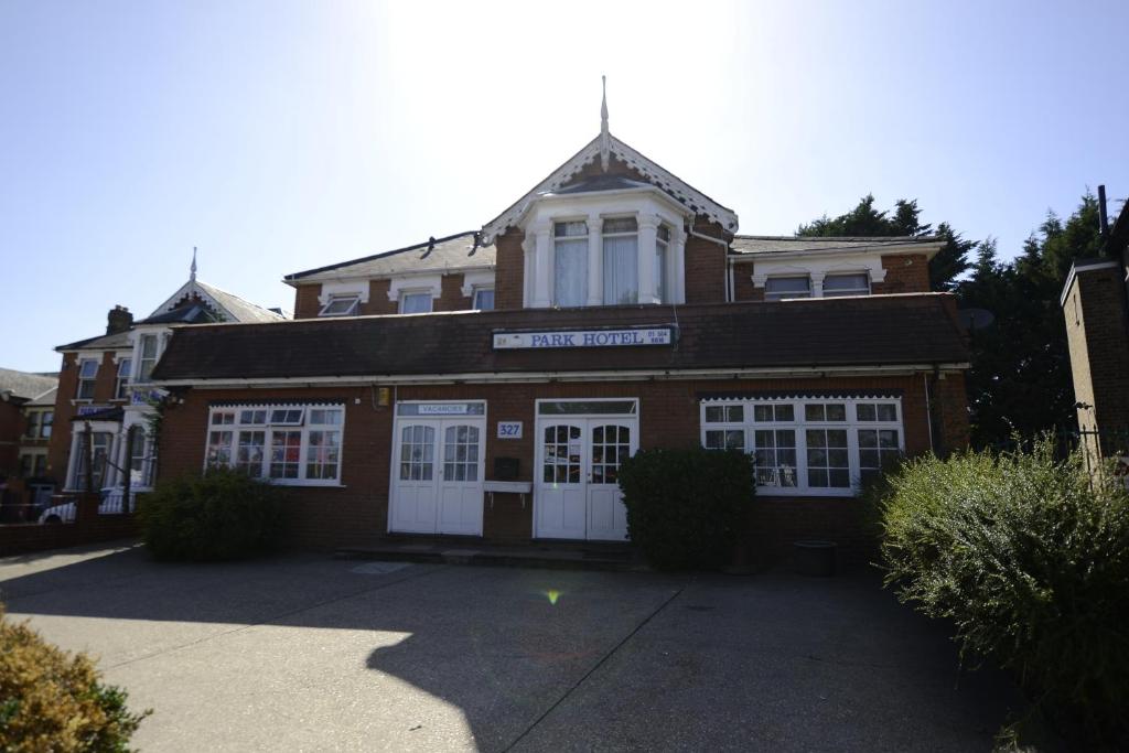 a large brick building with white doors and windows at Park Hotel in Ilford