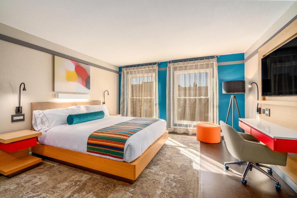 
a bedroom with a bed and a desk at Century Park Hotel LA in Los Angeles
