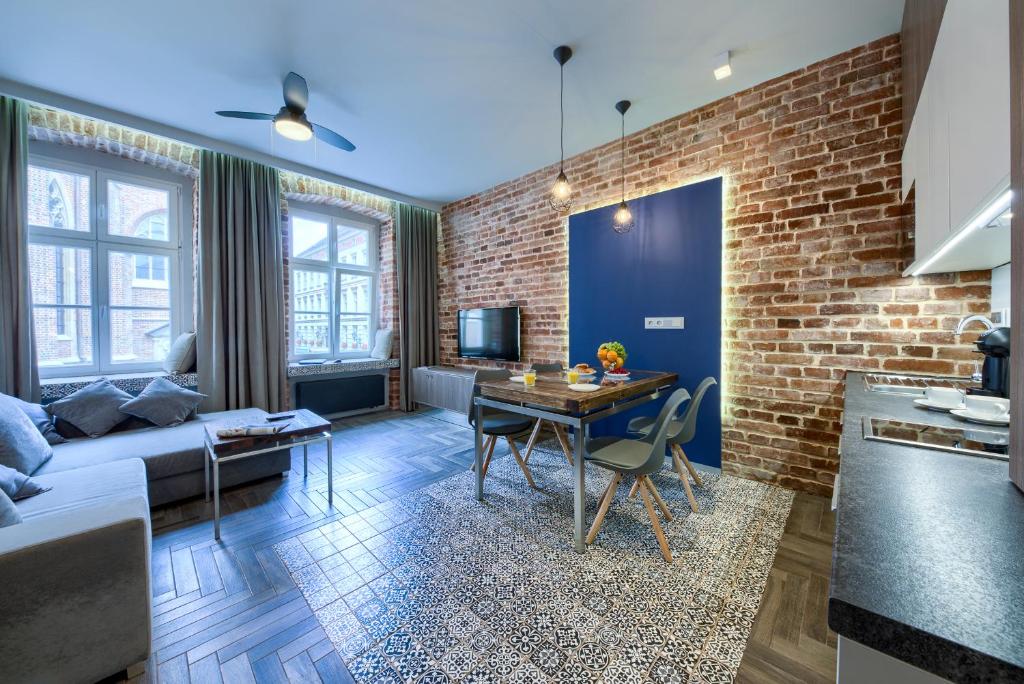a living room with a couch and a table at 2/3 APARTMENTS Old Town in Wrocław