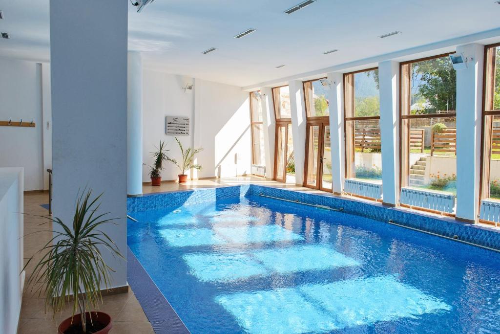 a swimming pool with blue water in a house at Mountain View Aparthotel in Bansko