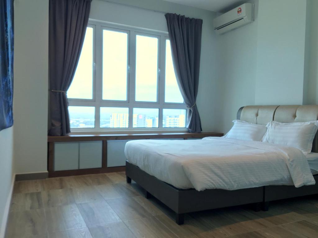 a bedroom with a bed and a large window at PM Octagon Ipoh Duplex Suite (4-12paxs) in Ipoh