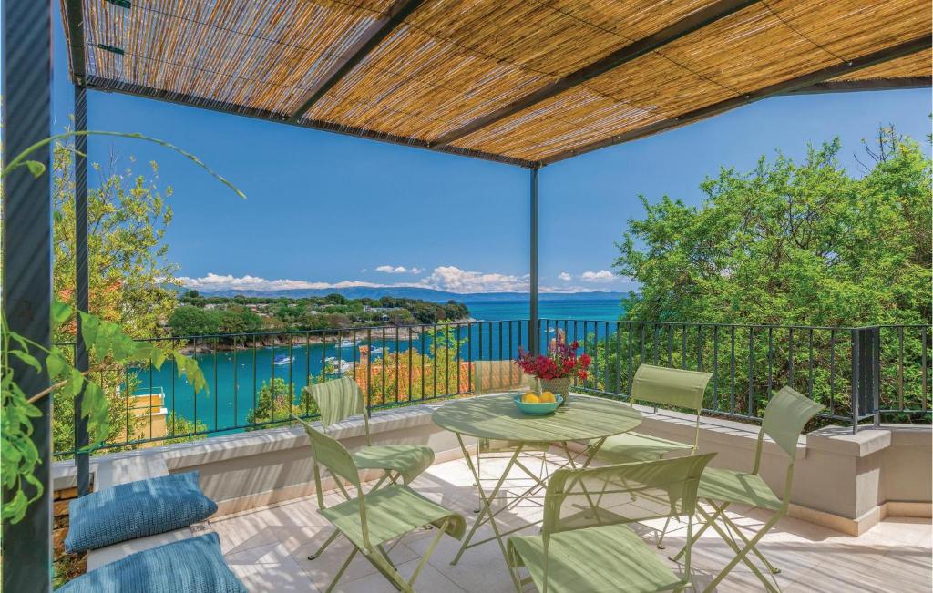 a patio with a table and chairs and a view of the water at Awesome Home In Labin With Kitchen in Labin