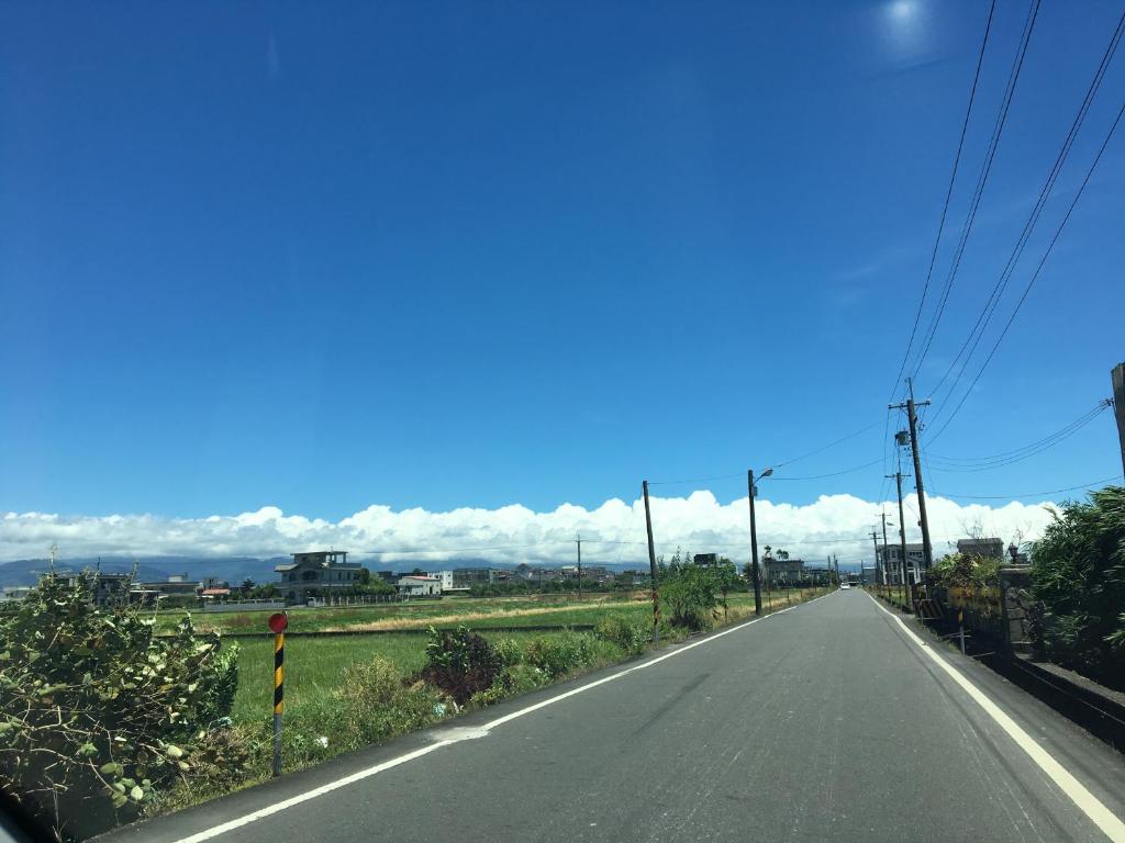 an empty road with clouds in the sky at Yilan Real Fun Homestay in Dongshan