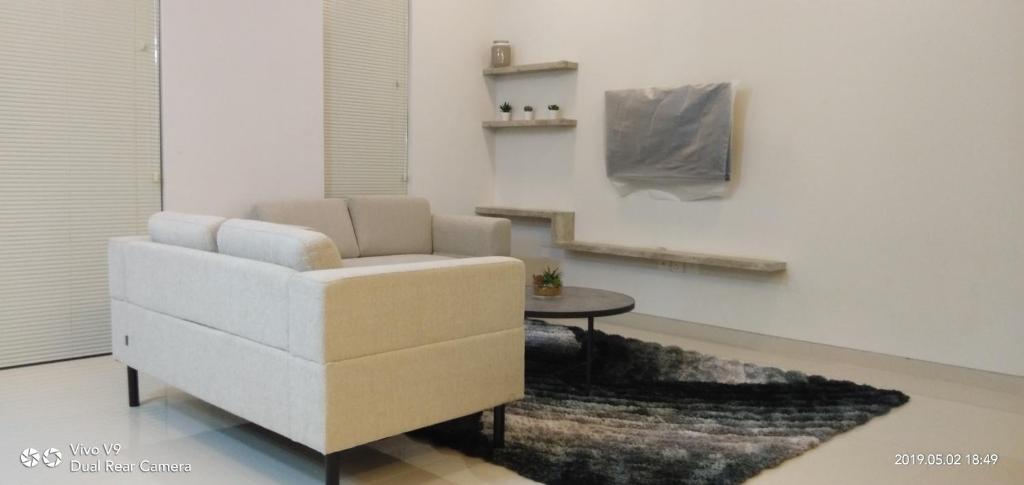 a living room with a white chair and a table at SleepRest @ The Home Shoutlink in Nagoya