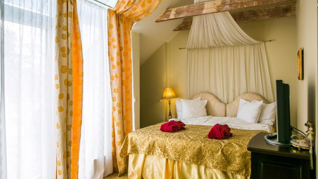Postel nebo postele na pokoji v ubytování Grand Rose SPA Hotel