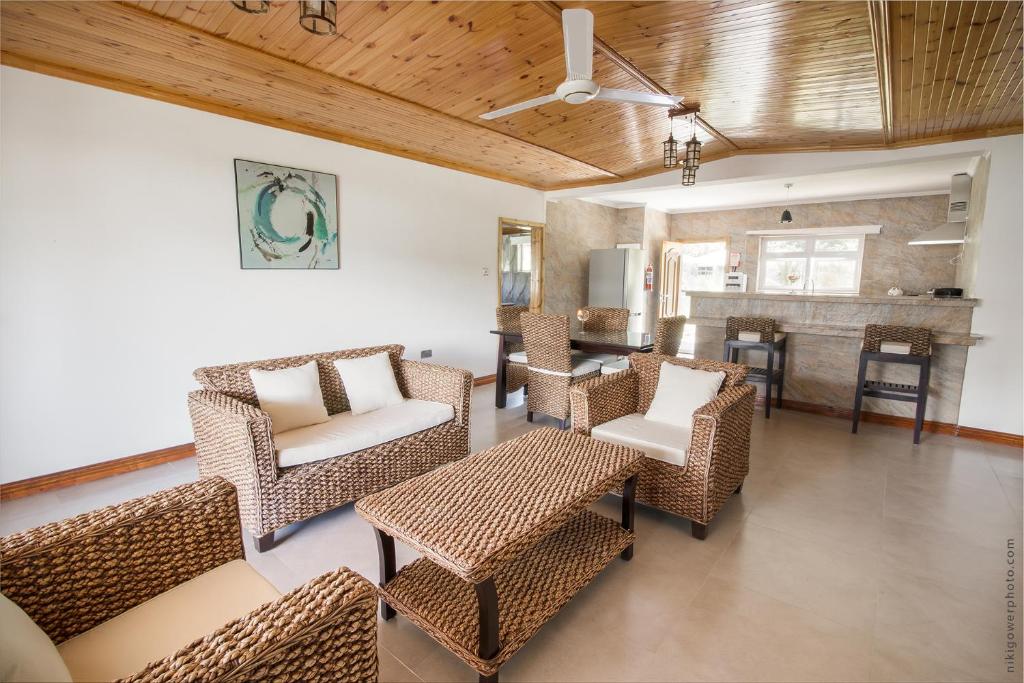 a living room with wicker chairs and a table at Flora's Self Catering Apartments in Victoria