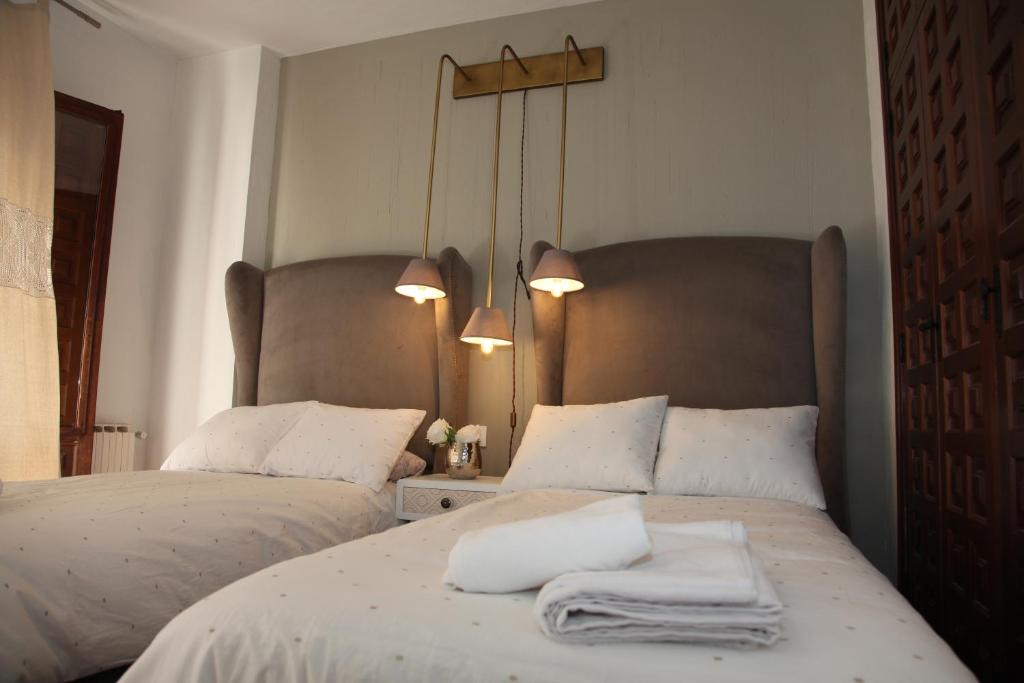 a bedroom with two beds with white towels on them at Apartamento San Juan in Cuenca