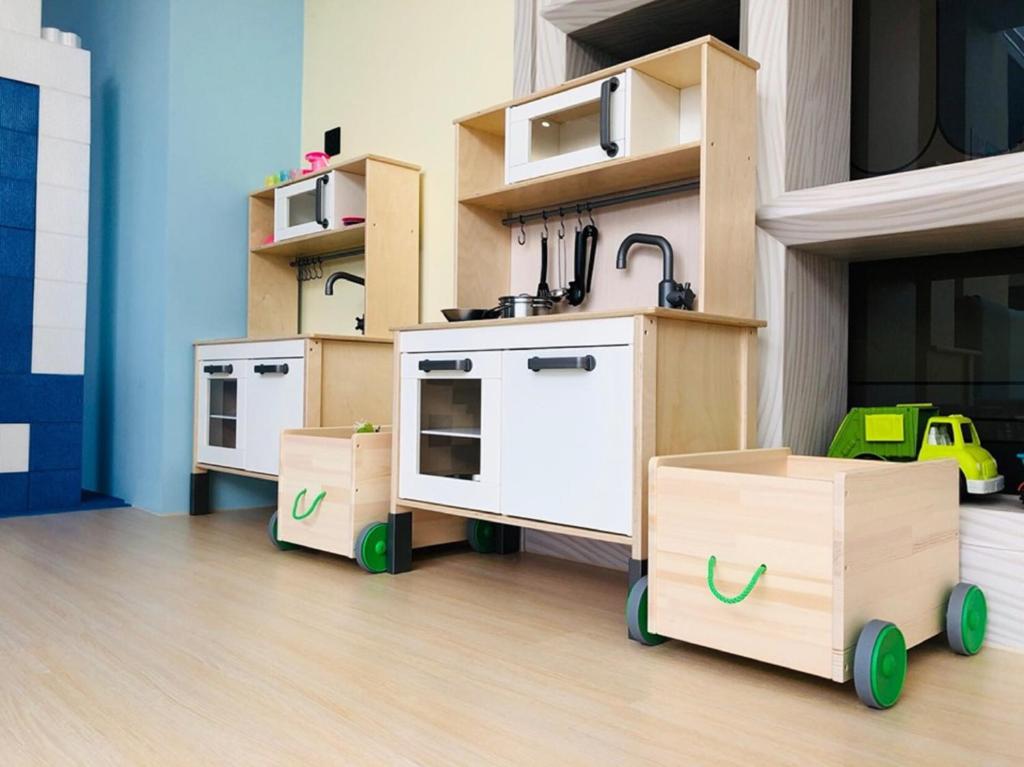 a room with three play kitchens with wooden cabinets at Icloud Luxury Resort &amp; Hotel in Taichung
