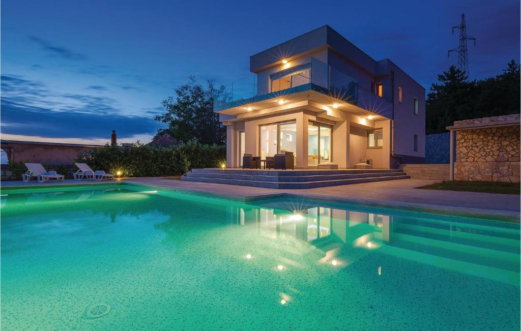 a house with a swimming pool in front of a house at Cozy Home In Crikvenica With Wifi in Crikvenica