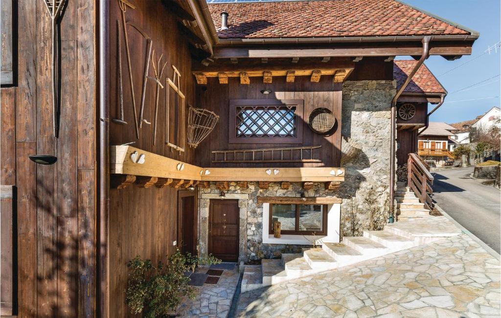 a wooden building with a window and a door at Pettirosso 1 in Comeglians