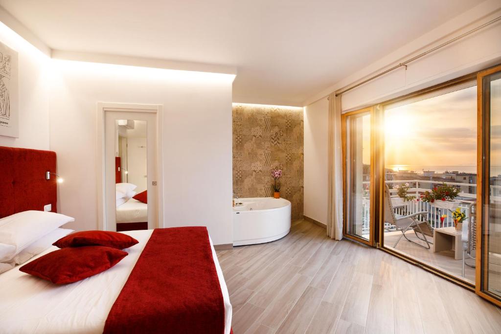 a bedroom with a large bed and a bath tub at Le Muse Suite in Sorrento