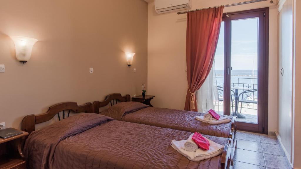 Postel nebo postele na pokoji v ubytování Poseidonio Hotel