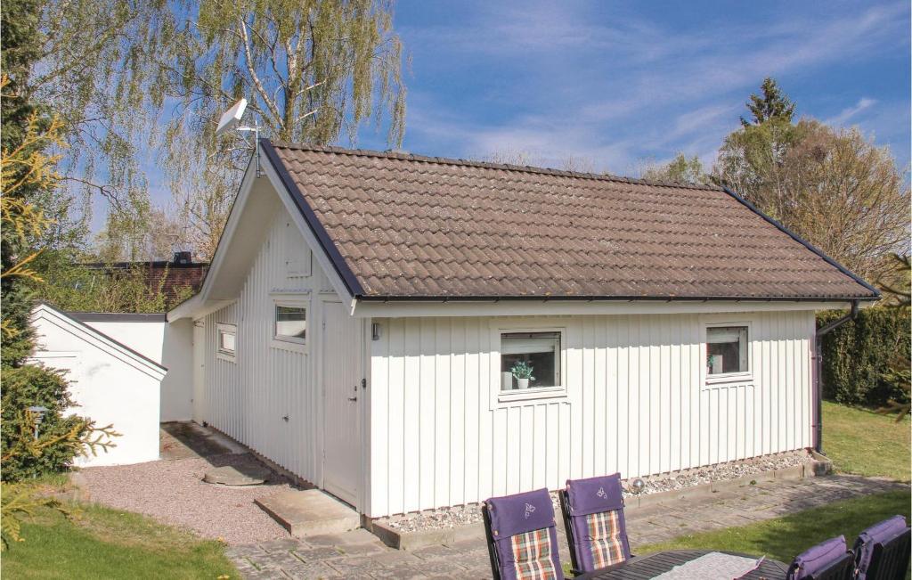 a white garage with two chairs in front of it at Amazing Home In Nttraby With Kitchen in Nättrabyhamn