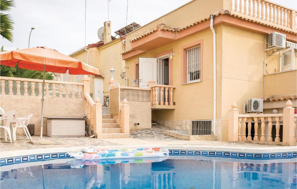 a house with a swimming pool in front of a house at Urb,la Marina in La Marina