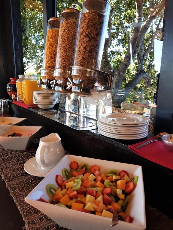 a plate of food on a table with a bowl of food at Greenfire Game Lodge in Balule Game Reserve