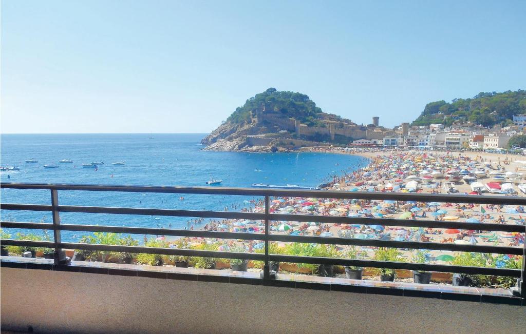a beach with a crowd of people and the ocean at Stunning Apartment In Tossa De Mar With 3 Bedrooms And Wifi in Tossa de Mar