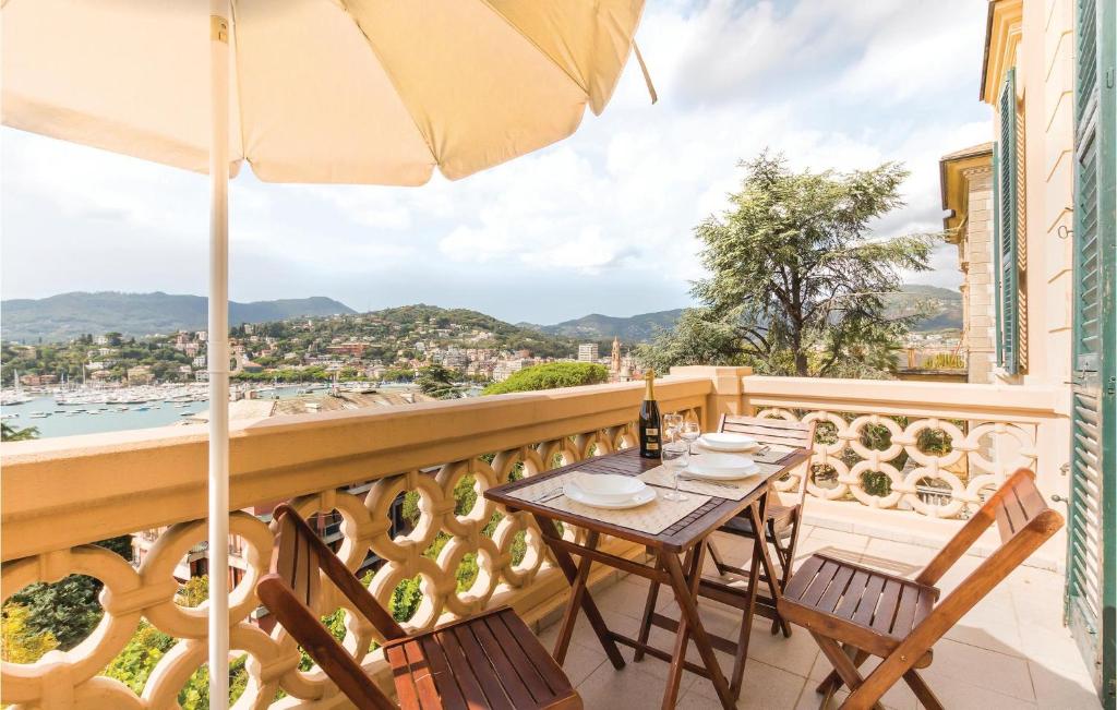 a balcony with a table and chairs and an umbrella at Casa Bellavista in San Michele di Pagana