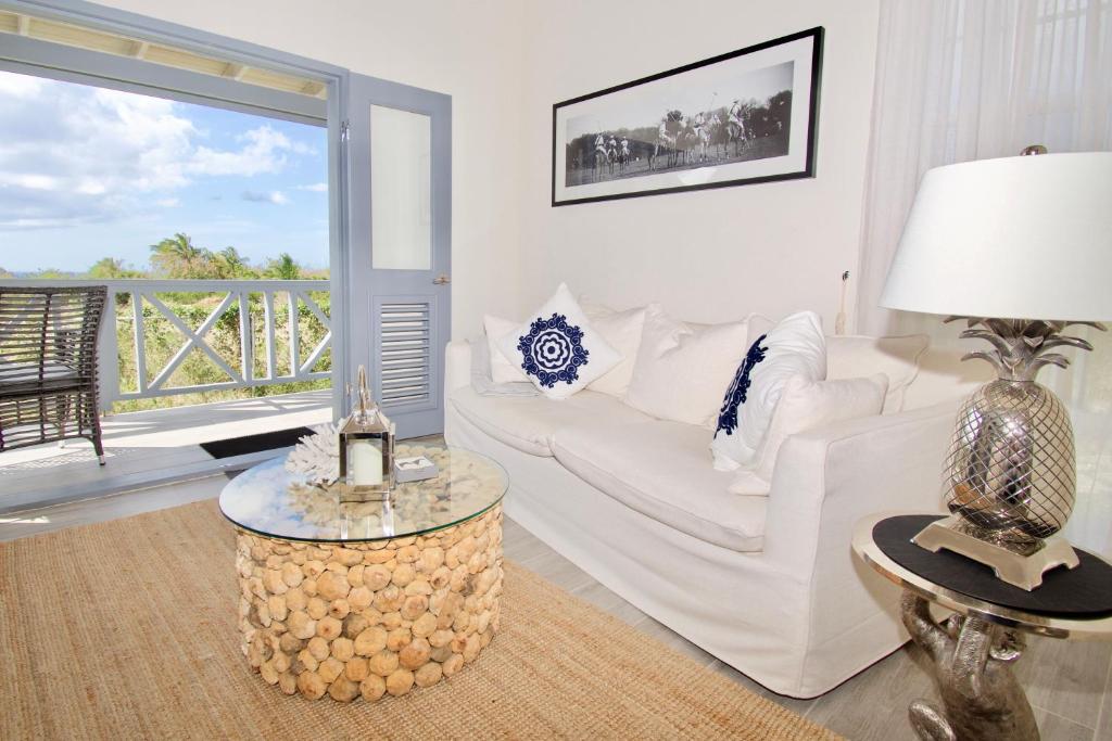 a living room with a white couch and a table at West Rock Villas in Saint James