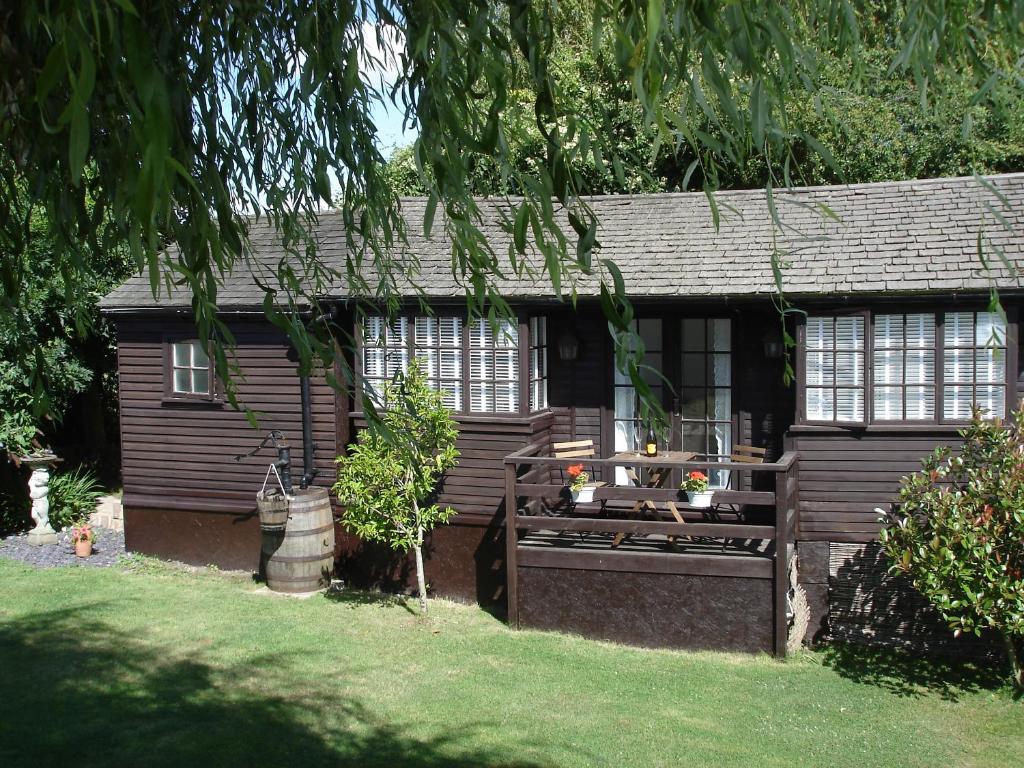 a small house with a porch and a yard at HOLLYDENE LODGE in Whitstable