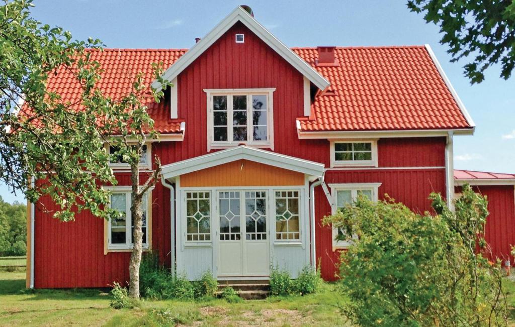 a red house with a red roof at Cozy Home In Skillingaryd With Wifi in Nydala