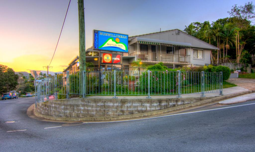 a building with a sign on the side of it at Murwillumbah Motor Inn in Murwillumbah