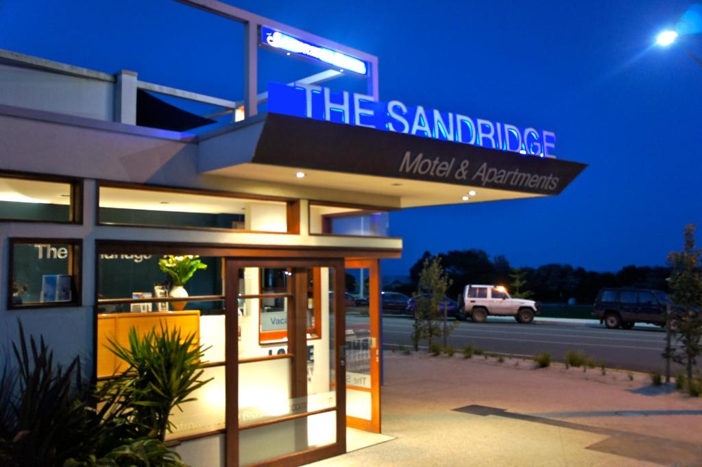a building with a sign on the side of it at The Sandridge Motel in Lorne