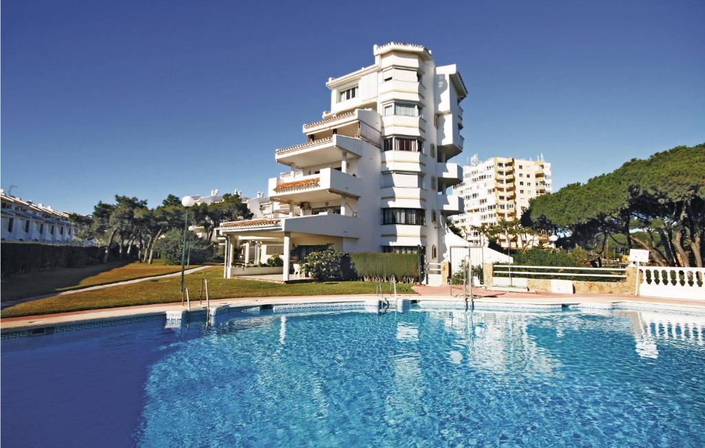a large swimming pool in front of a building at Stunning Apartment In Calahonda With 3 Bedrooms, Wifi And Outdoor Swimming Pool in La Cala de Mijas