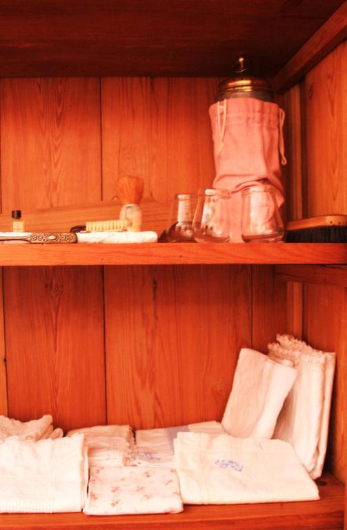 a wooden shelf with towels and other items on it at Sintra Small Hostel in Sintra