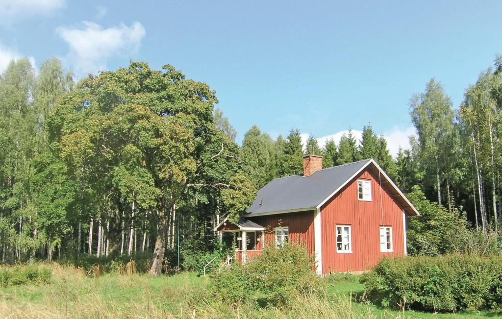 a red house in the middle of a field at Amazing Home In Molkom With 2 Bedrooms in Sutterhöjden