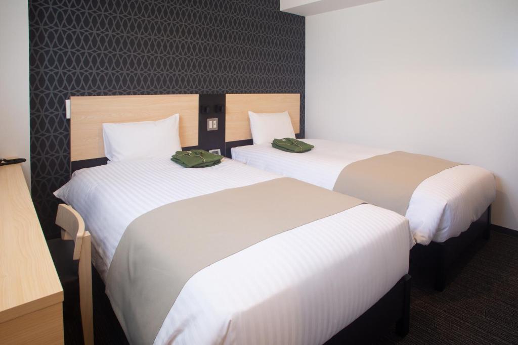 Postel nebo postele na pokoji v ubytování Hotel Kuretakeso Hiroshima Otemachi