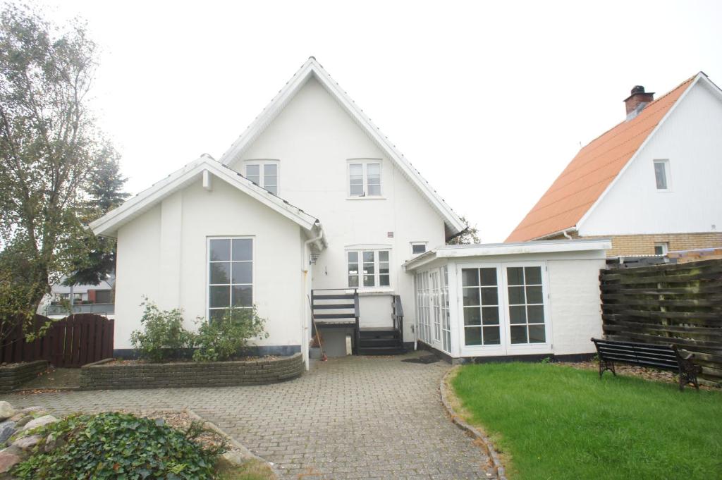 a white house with a patio and a yard at Sædding Strandvej (ID 119) in Esbjerg