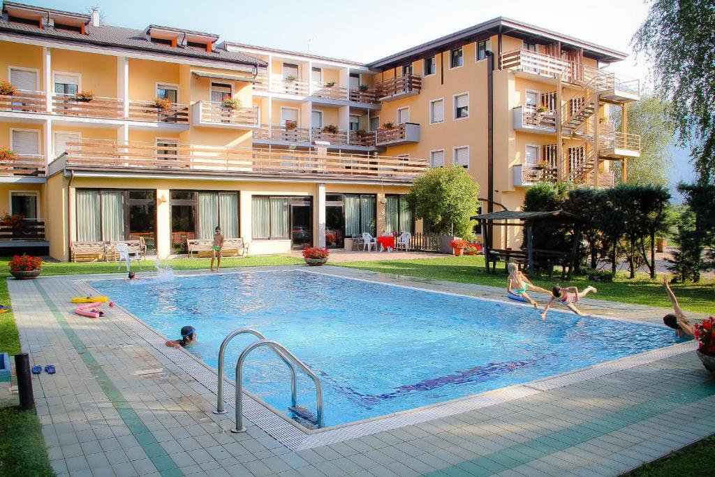 a group of people playing in a swimming pool at Hotel Dolomiti in Levico Terme
