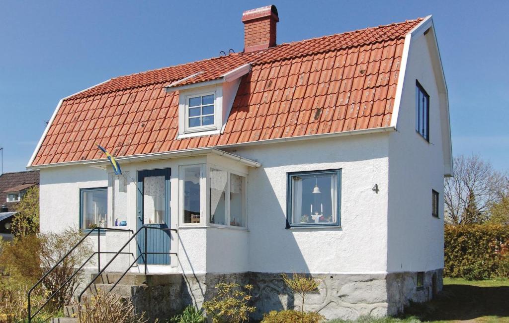 a white house with an orange roof at Awesome Home In Slvesborg With Kitchen in Hällevik