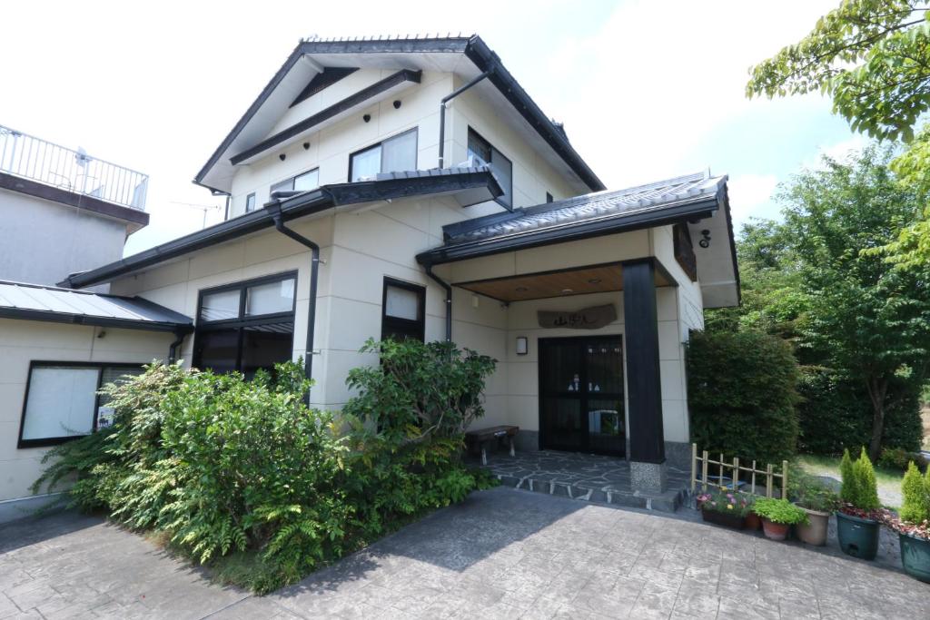 an image of a house with a driveway at Yufuin Yamaboushi in Yufu